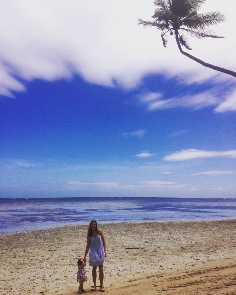 A child walking on a sunny beach