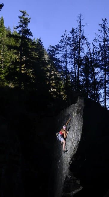 Climbing a rock face in the forest