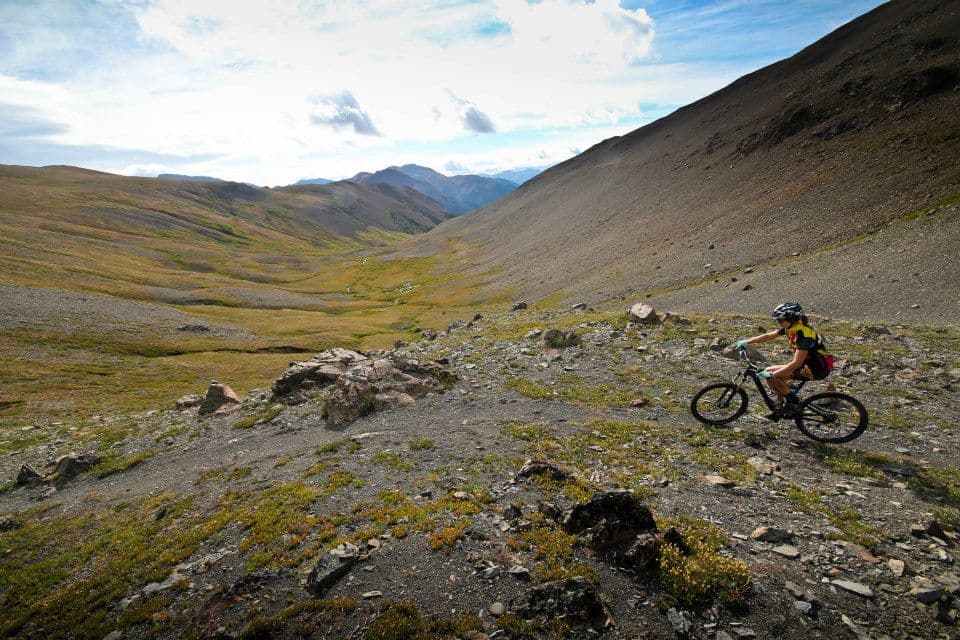 Mountain biking down a rocky alpine valley